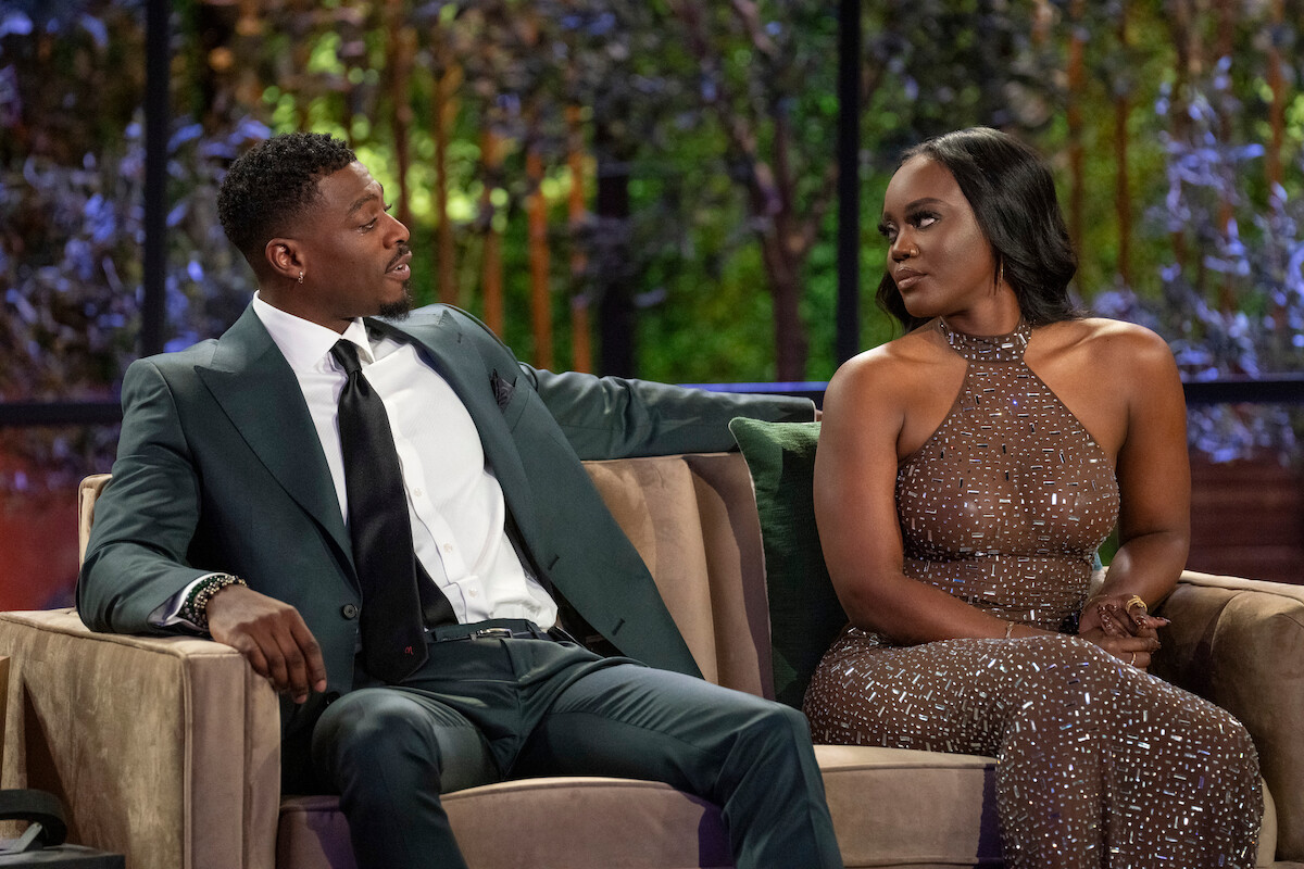 Clay Gravesend and AD Smith speaking on a couch in the season 6 reunion of Love is Blind.