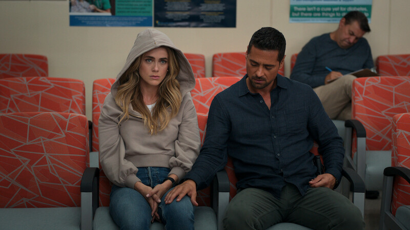 Two people sitting down in an airport