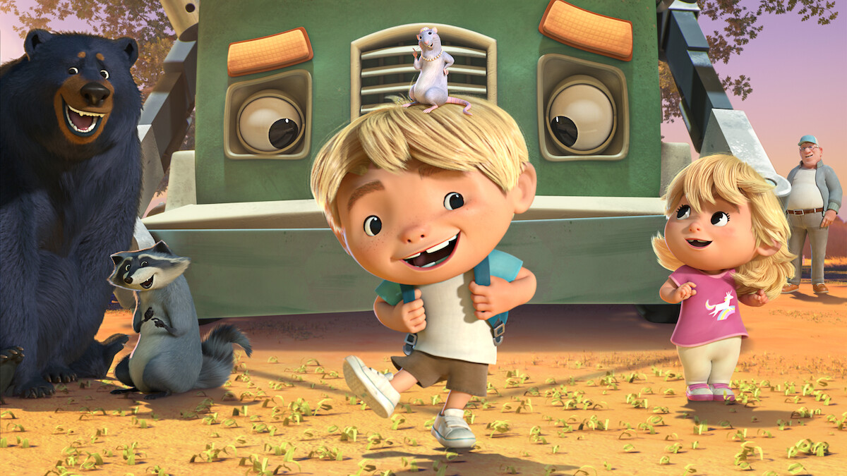 Two animated kids happily stand in front of a large green truck in a sunny outdoor setting, joined by smiling animal friends including a bear, raccoon, and a mouse on the boy’s head, with trees and an adult in the background.