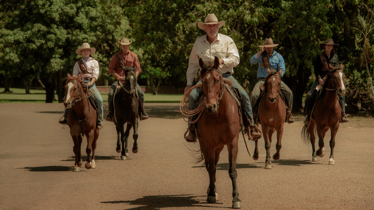 Philippa Northeast as Susie Lawson, Sam Corlett as Marshall Lawson, Robert Taylor as Colin Lawson, Michael Dorman as Graham Lawson, and Anna Torv as Emily Lawson ride horses through a ranch in Season 1 of ‘Territory’