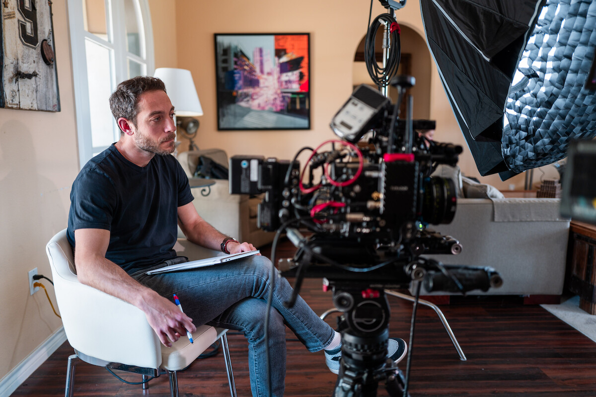 ‘Court of Gold’ director Jake Rogal sits behind a camera.