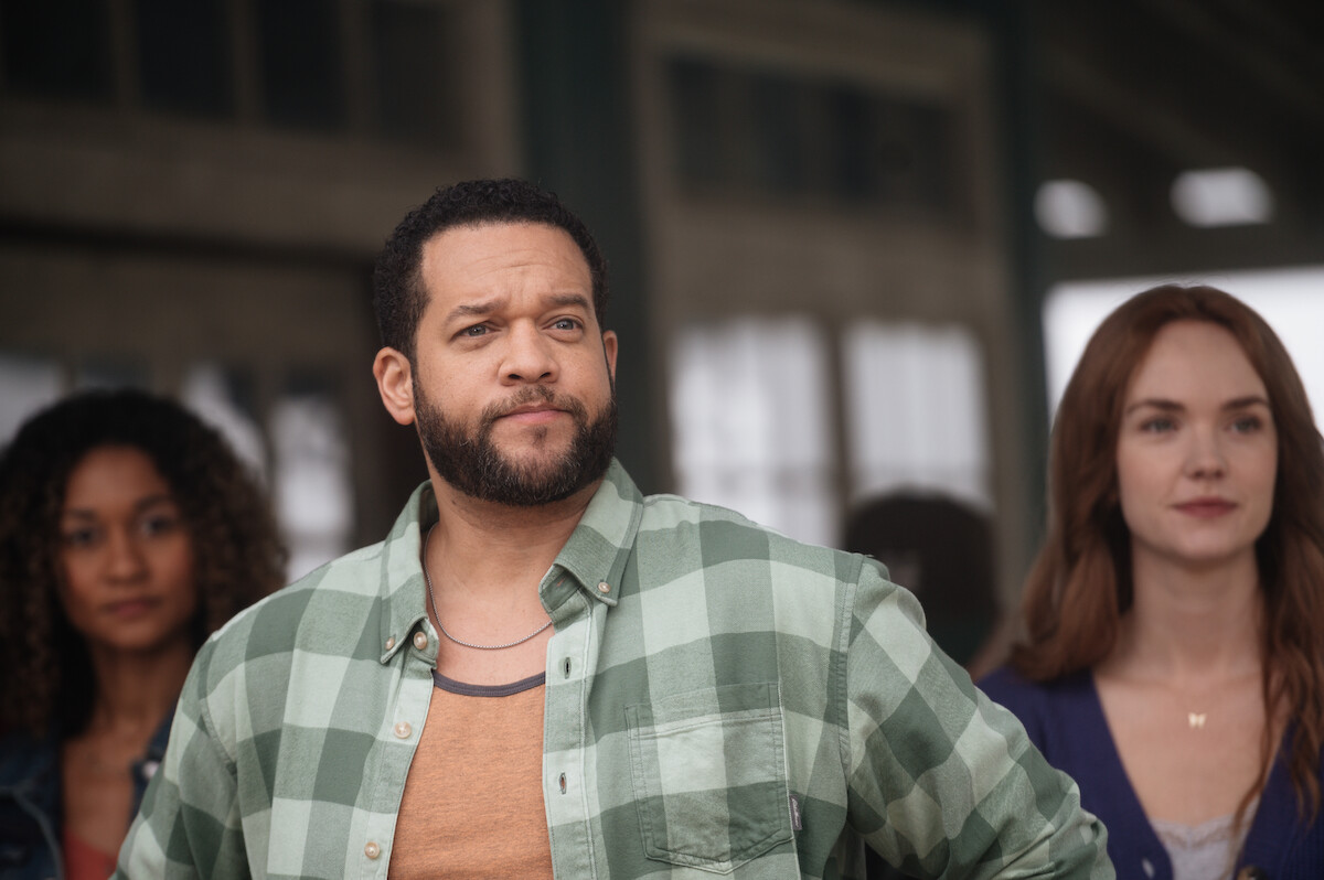 Reid Price as Rob Shandon observes a crowd in a production still of ‘Sullivan’s Crossing.’