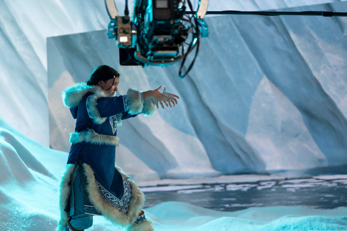 Behind the scenes photo of Kiawentiio as Katara performing water bending in season 1 of ‘Avatar: The Last Airbender’
