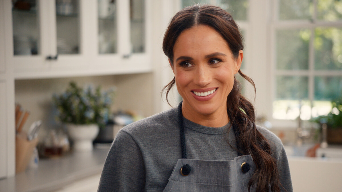Meghan smiling in the kitchen.