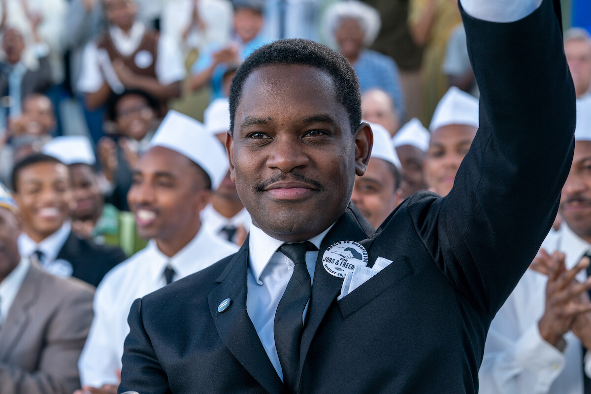 Aml Ameen as Martin Luther King waves to a crowd of people in ‘Rustin’