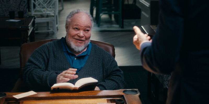 Stephen McKinley Henderson as Calbert reads a book in Season 1 of 'A Man on the Inside'