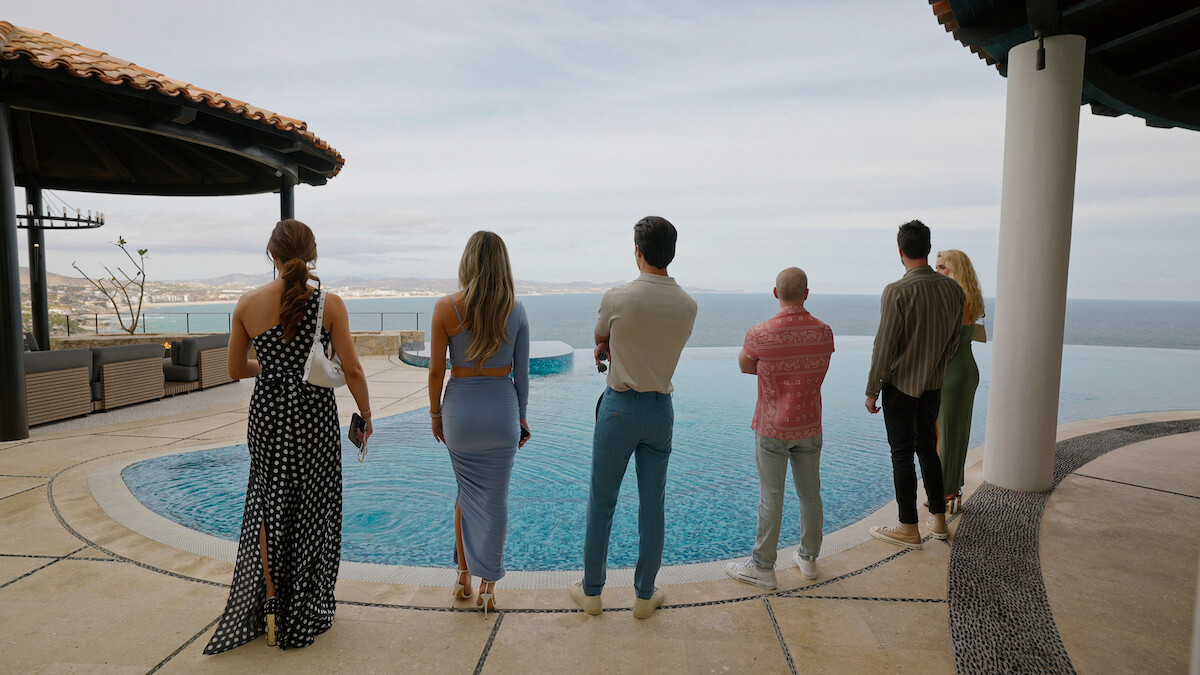 Polly Brindle, Alex Hall, Gio Helou, Jason Oppenheim, Tyler Stanaland, and Alexandra Jarvis stand around a pool.