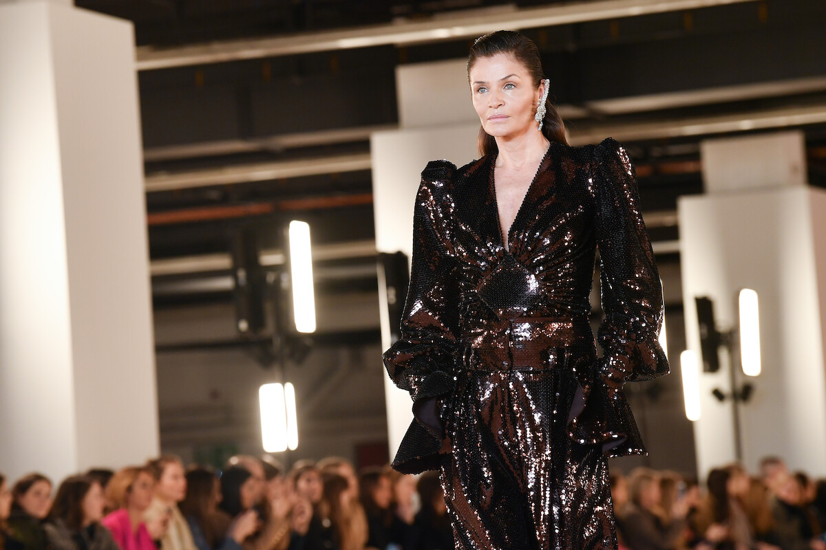 Helena Christensen walks the runway at fashion show. 