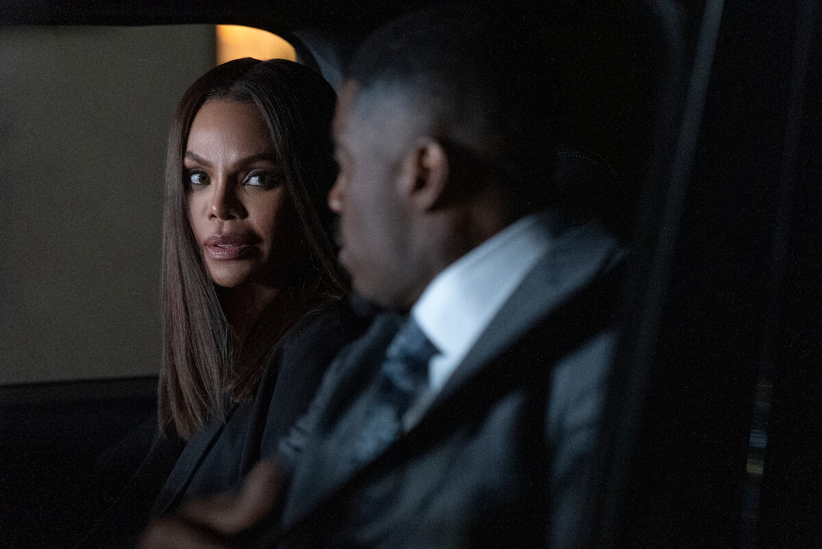 Crystle Stewart as Mallory and Terrell Carter as Varney sit in a dimly lit car at night, one woman looking intently at a man in a suit beside her, suggesting a serious conversation or tense moment.
