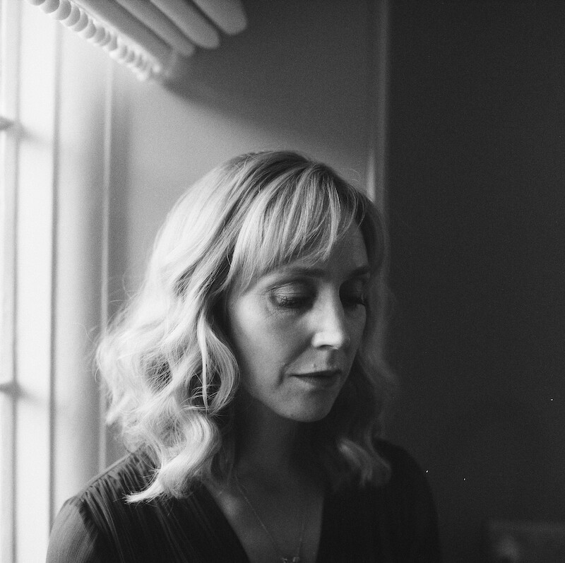 Black-and-white image of Hattie Morahan as Caroline Burkett with window light behind her in Season 1 of 'Fool Me Once'