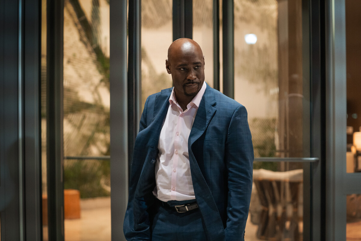 D.B. Woodside stands in front of a revolving door in a still from ‘The Perfect Find.’