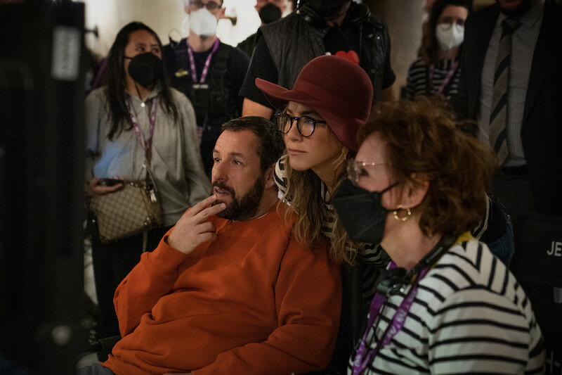 Adam Sandler as Nick Spitz, Jennifer Aniston as Audrey Spitz and Script Supervisor Ronit Ravich-Boss with crew members.