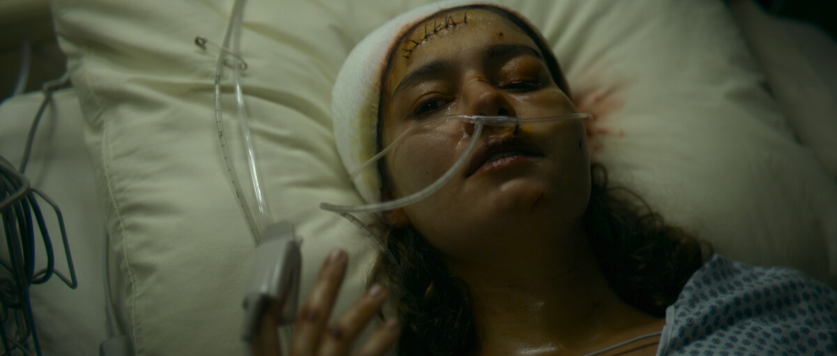 Sophie Charlotte as Magdala lays in a hospital bed in ‘The Killer’