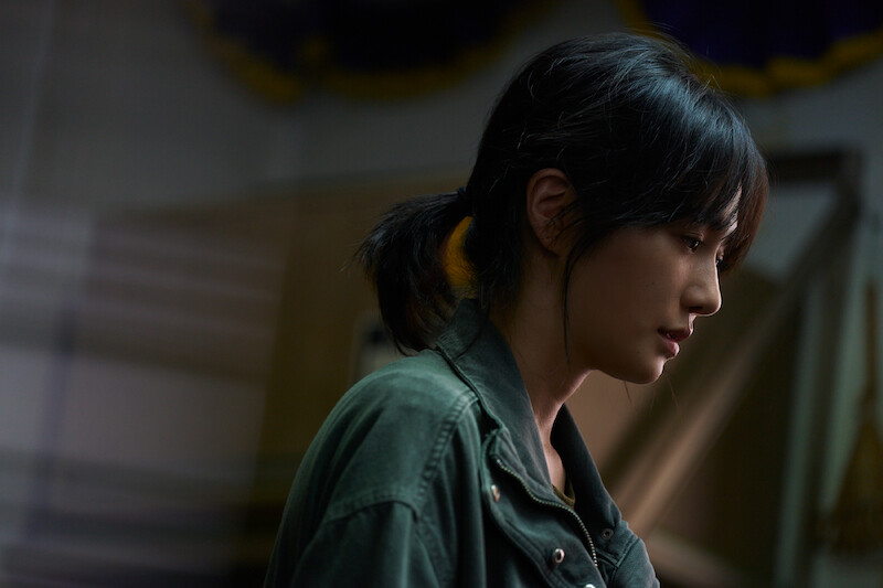 A woman looks down sadly in Season 2 of 'Squid Game'