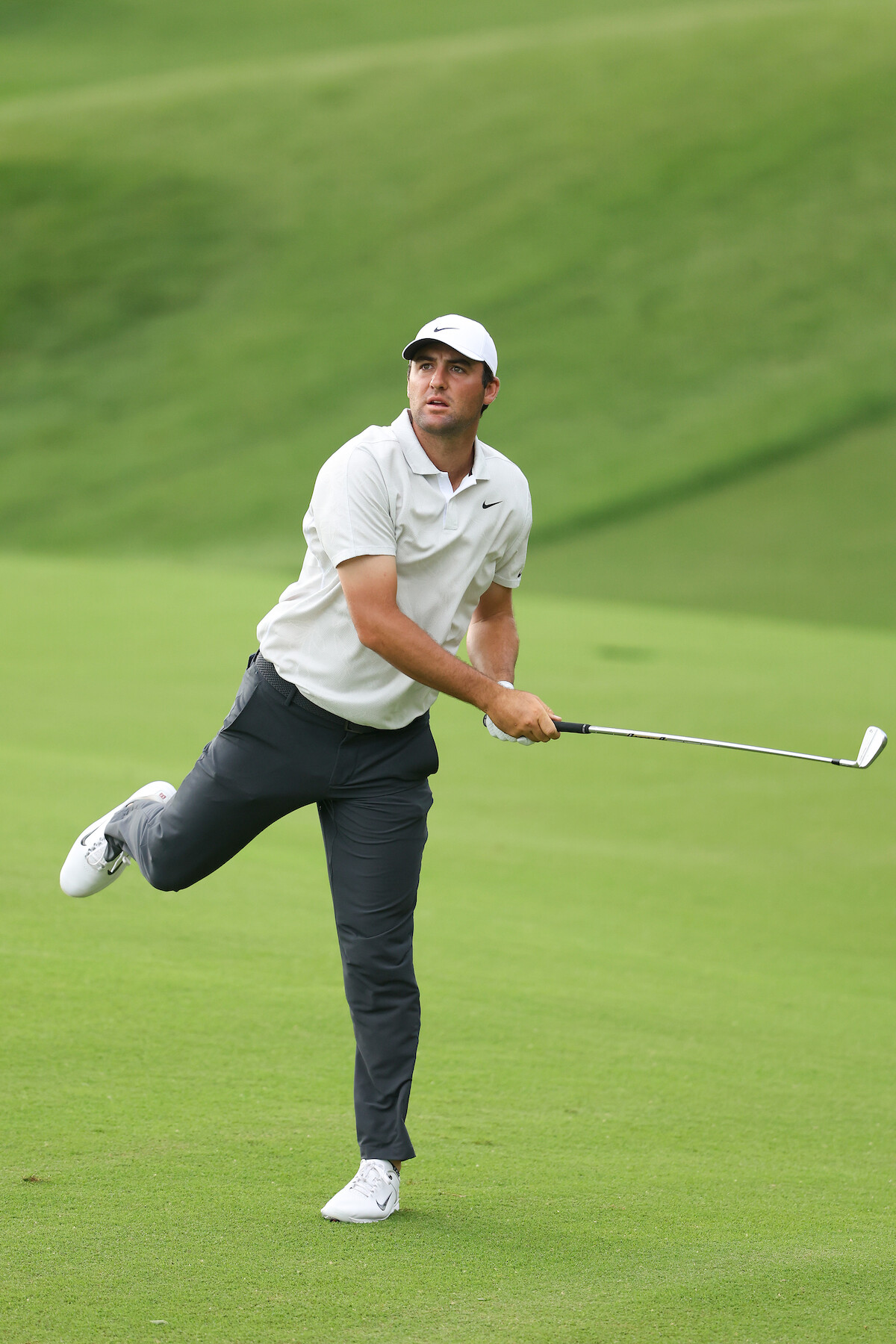 Golfer Scottie Scheffler mid-swing.