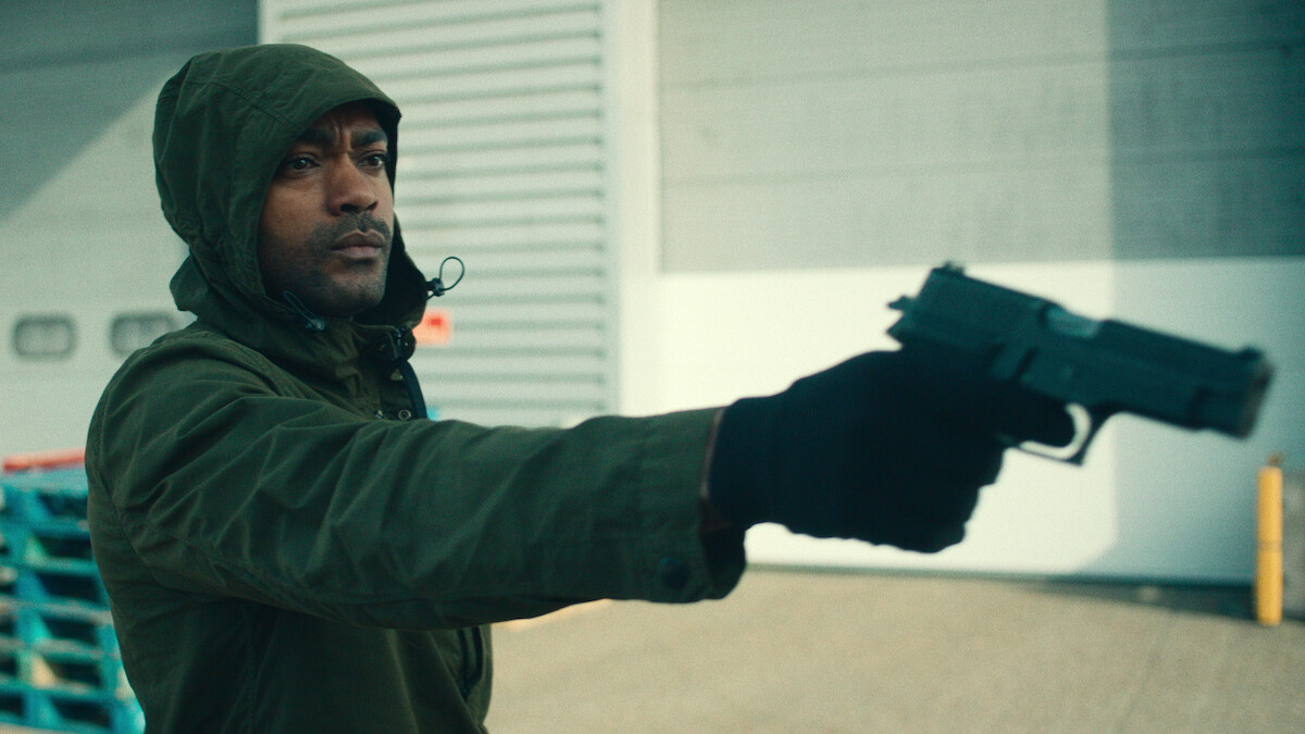 Kane Robinson as Sully holds a gun in Season 3 of ‘Top Boy.’