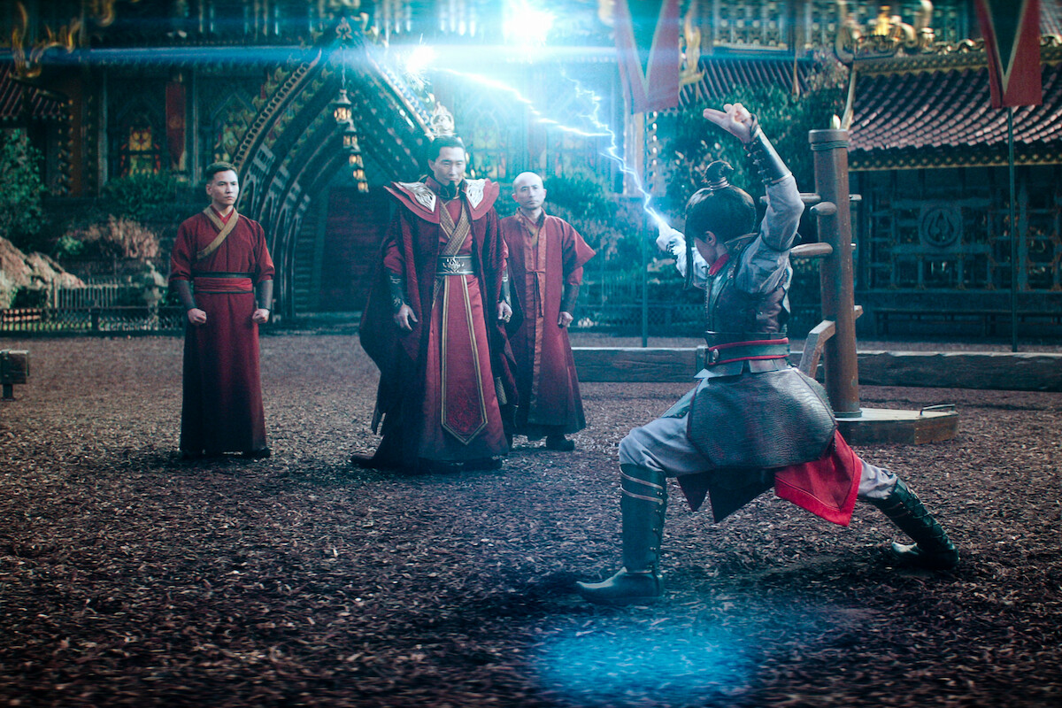 Daniel Dae Kim as Ozai watches Elizabeth Yu as Azula perform fire bending with blue electricity in season 1 of ‘Avatar: The Last Airbender’