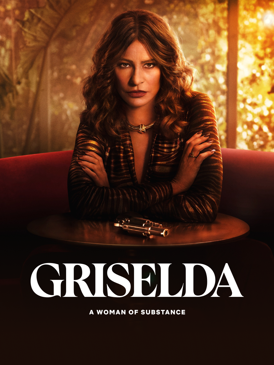 Sofia Vergara as Griselda sitting behind a table