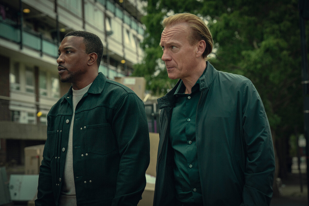 Ashley Walters as Dushane and Shaun Dingwall as Jeffrey stand together outside in Season 3 of ‘Top Boy.’