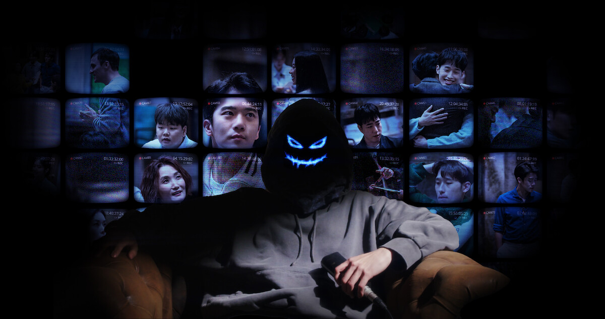A masked man sits in front of a wall of television screens in Season 1 of ‘The Devil’s Plan.’
