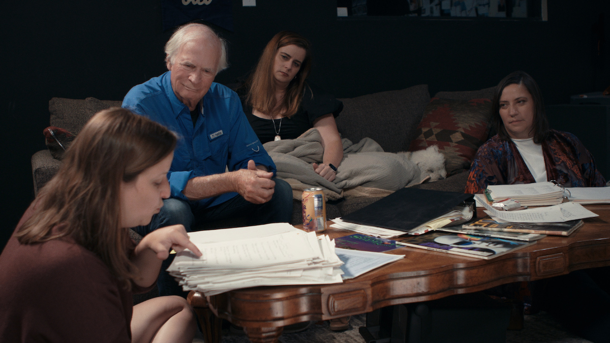 Katherine Kubler, Ken, and Julie looking over documents.