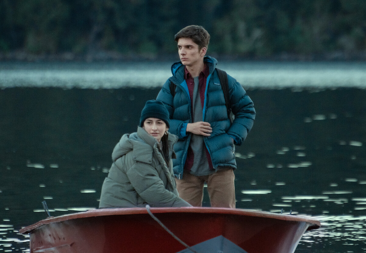 A young woman sits next to Matías Recalt as Bruno in a small boat in an image from the series ‘Caught.’
