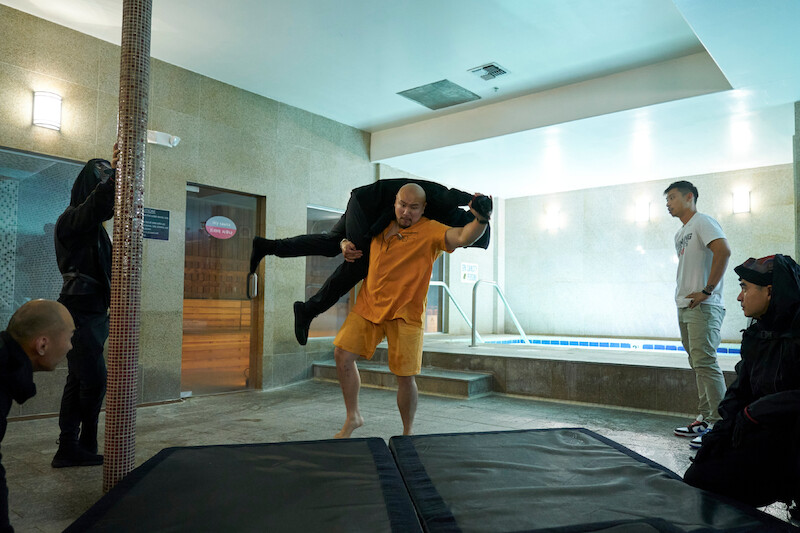 Jon Xue Zhang as Blood Boots, Director Justin Yu in episode 104 of The Brothers Sun.