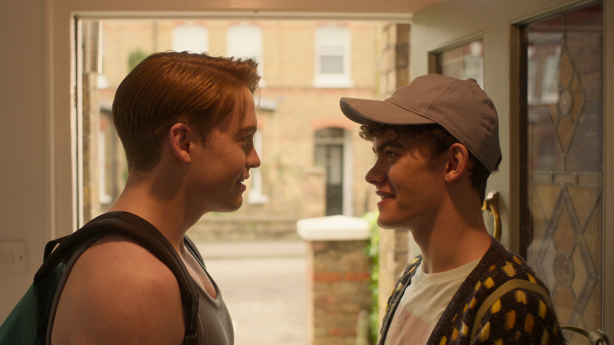 Kit Connor as Nick and Joe Locke as Charlie face each other smiling in Season 3 of 'Heartstopper'