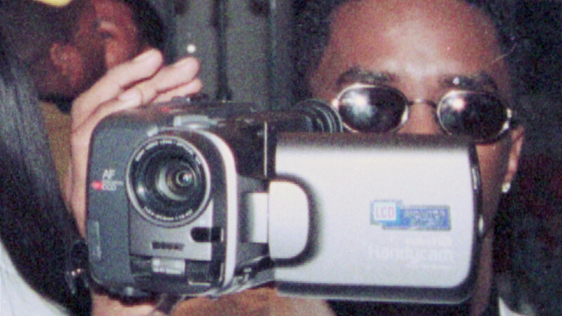 A man holds a digital video camera.
