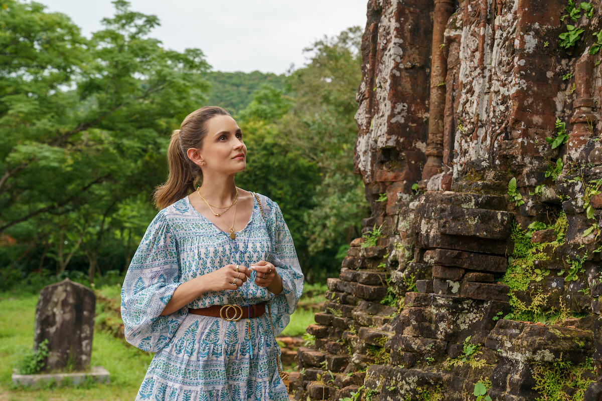 A woman explores outdoor ruins in a still from ‘A Tourist’s Guide to Love.'
