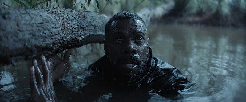 Colman Domingo as Muncie Daniels hides by a log in a river in Season 1 of ‘The Madness.’