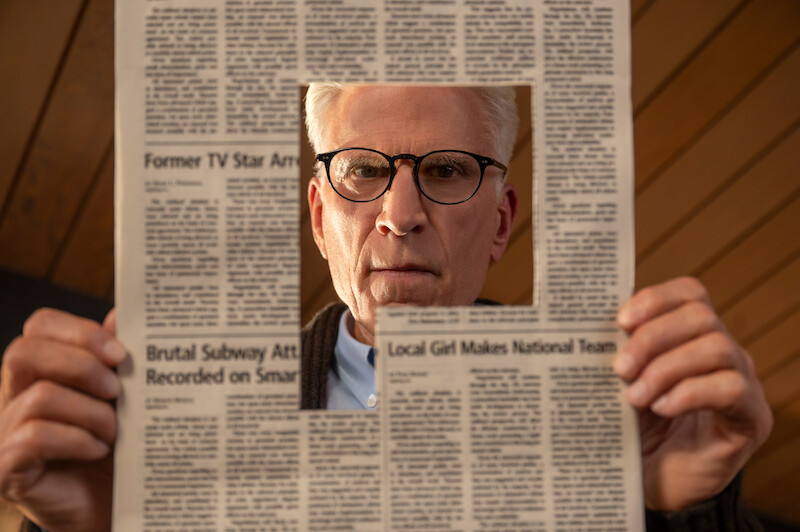 Ted Danson as Charles looks through a newspaper with a hole cut out from it in Season 1 of 'A Man on the Inside'
