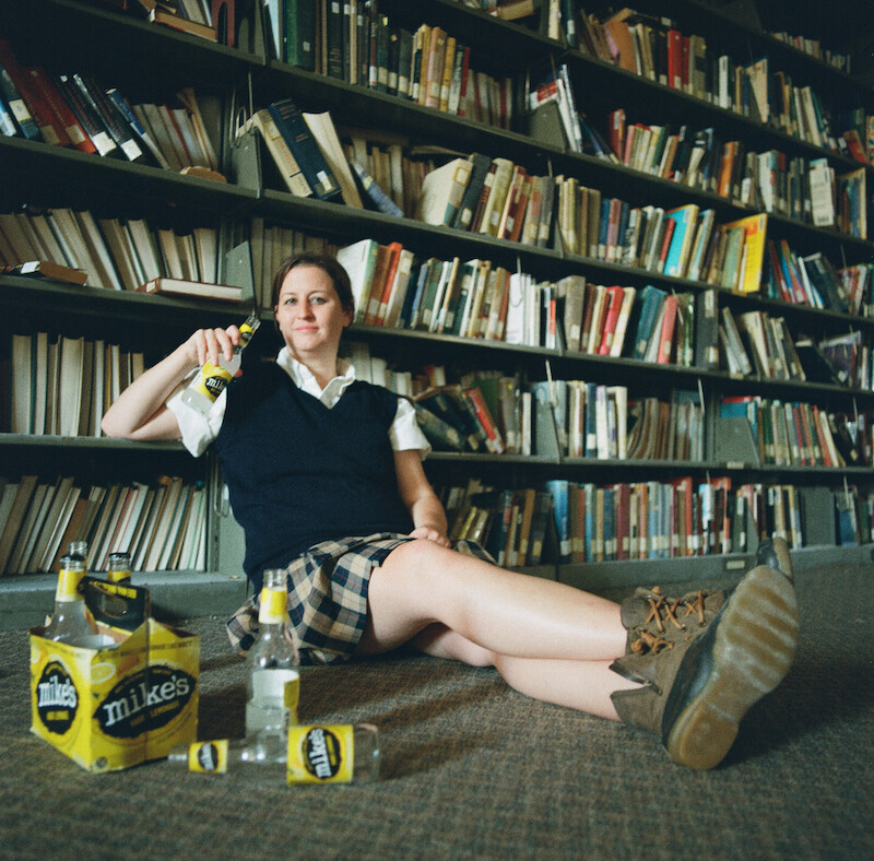 Katherine Kubler sitting in front of books at The Academy at Ivy Ridge