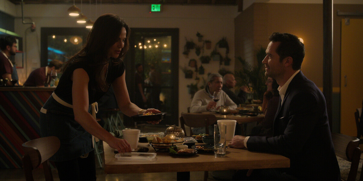 Lana Parrilla as Lisa Trammell and Manuel Garcia-Rulfo as Mickey Haller eating at elysian in ‘The Lincoln Lawyer’ Season 2.