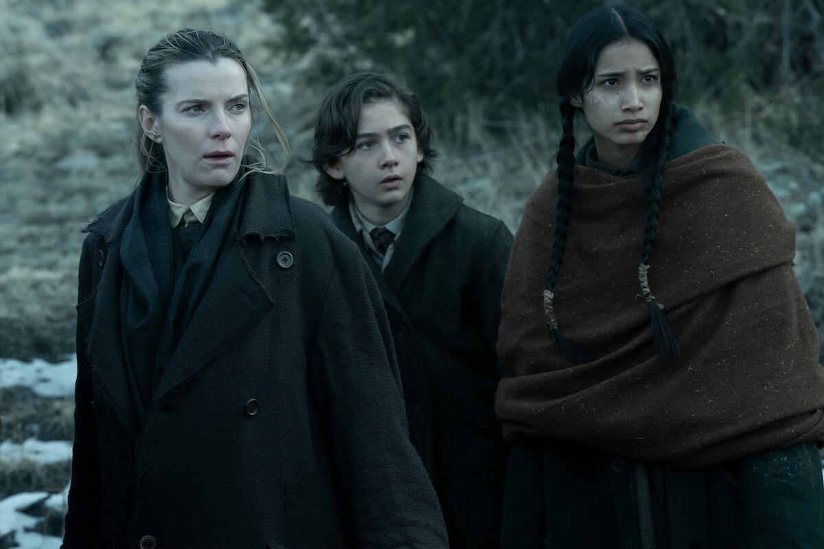 Betty Gilpin as Sara Rowell, Preston Mota as Devin Rowell, and Shawnee Pourier as Two Moons in ‘American Primeval’