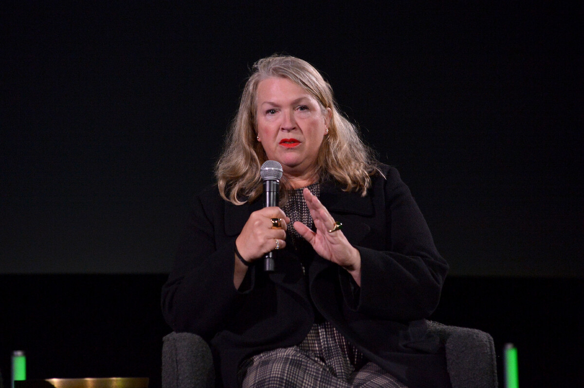 Kate Hawley holds a microphone.