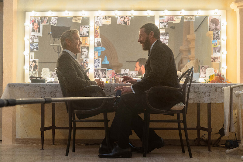 George Clooney as Jay Kelly and Adam Sandler as Ron Sukenick on the set of 'Jay Kelly.'