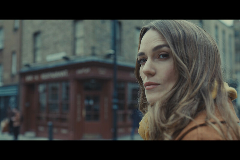 Close up of Keira Knightley walking down a street.