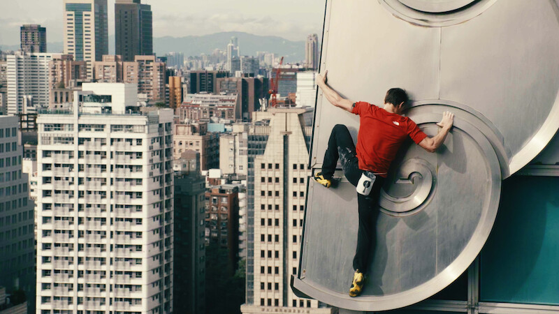 A man scales a tall building.
