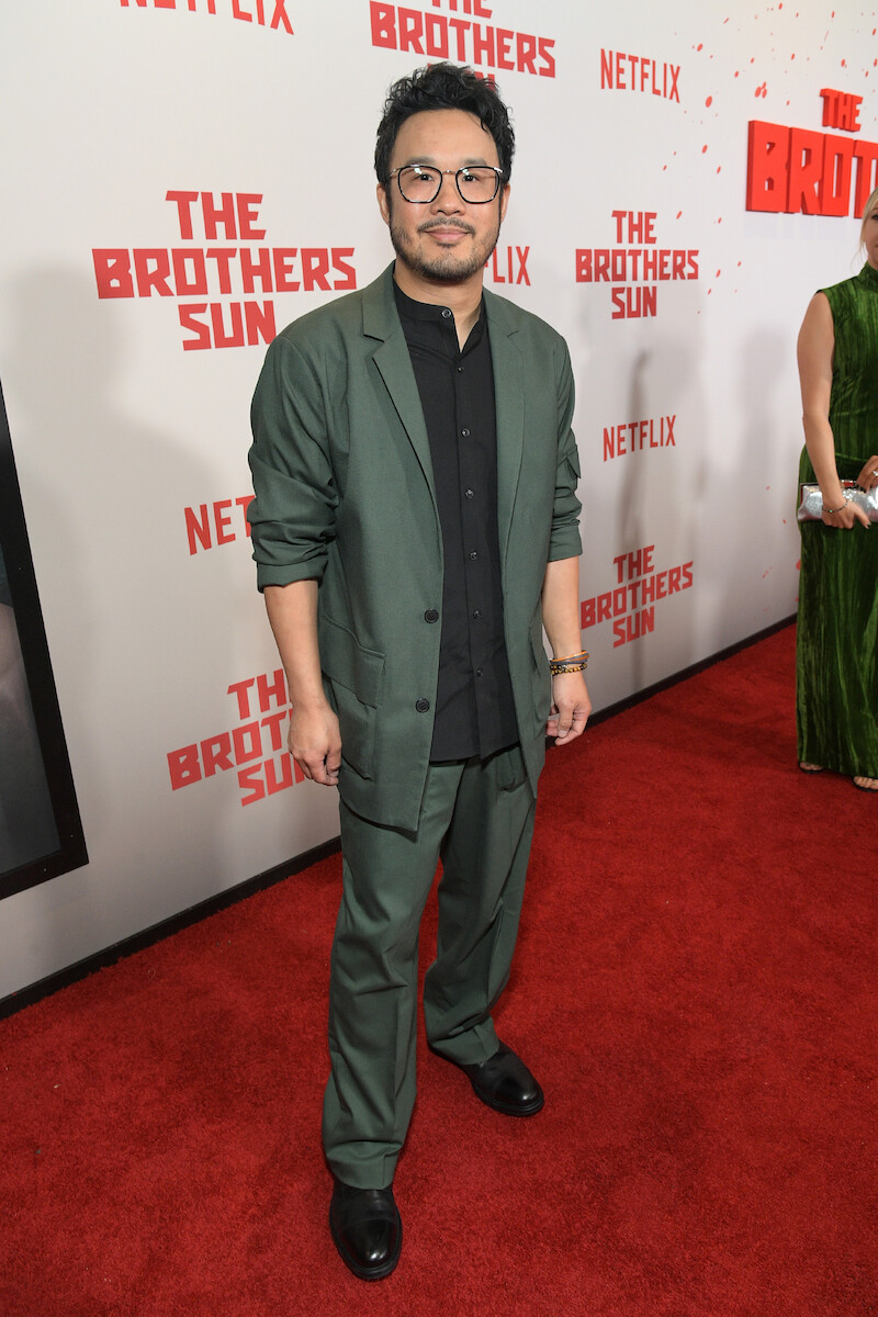 Kevin Tancharoen attends Netflix's 'The Brothers Sun' Los Angeles Premiere at Netflix Tudum Theater wearing a dark green suit