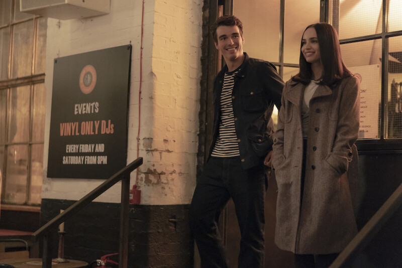 Corey Mylchreest as Jamie and Sofia Carson as Anna standing in front of a building in 'My Oxford Year'.