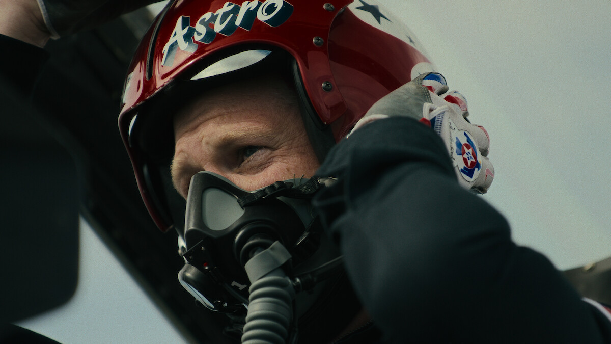 Pilot in a cockpit as other fighter jets fly by