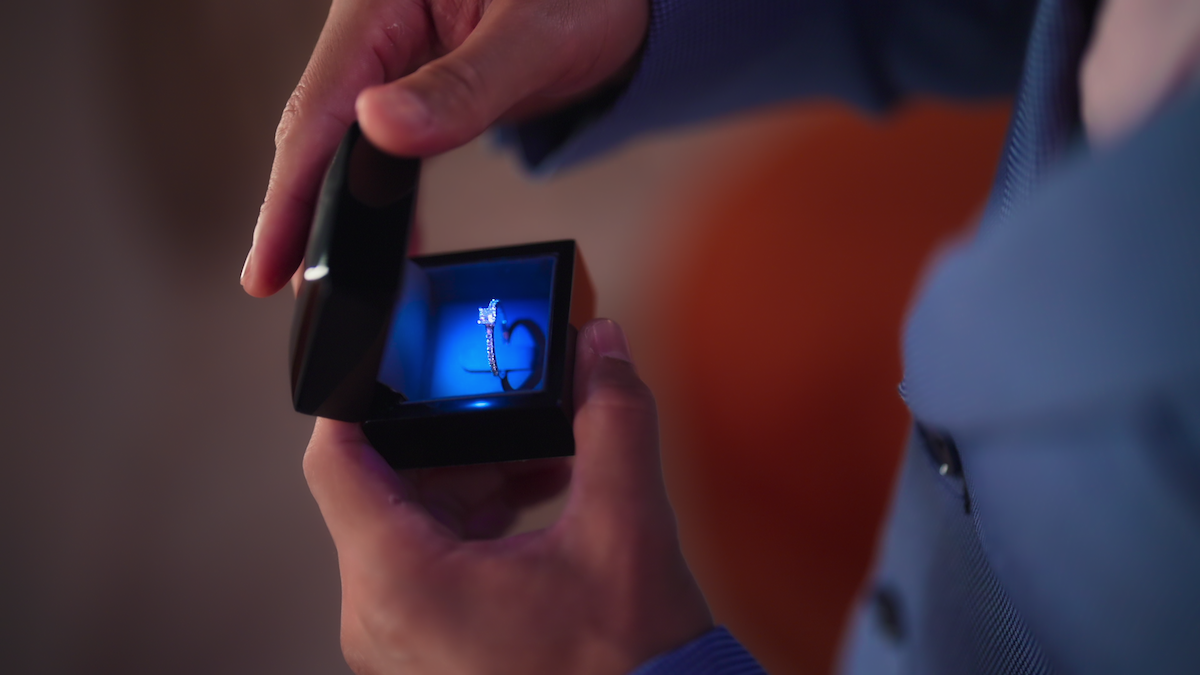 An engagement ring shown in a blue box.