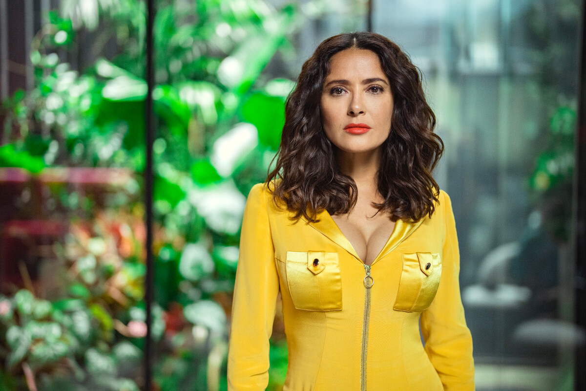 Salma Hayek as TV Joan in Black Mirror Season 6 portrait in yellow jumpsuit.