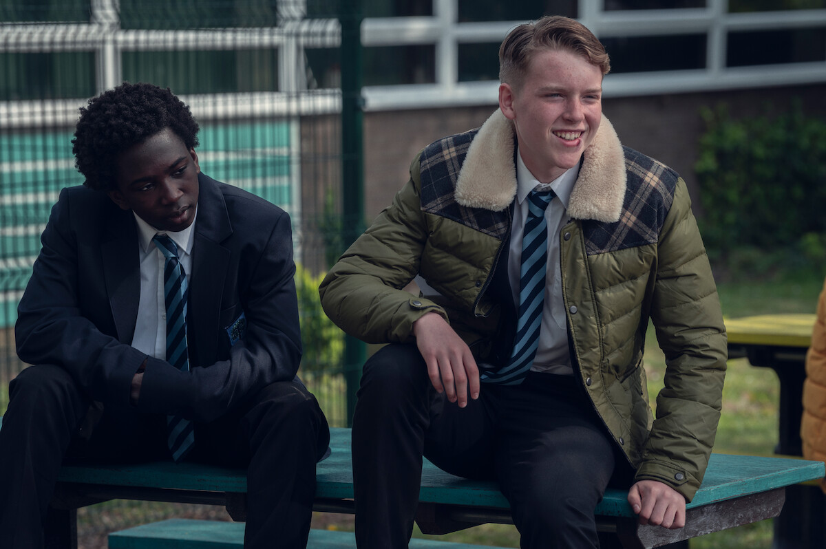 Cormac Hyde-Corrin as Harry sits outside of school in Season 1 of ‘Heartstopper.’