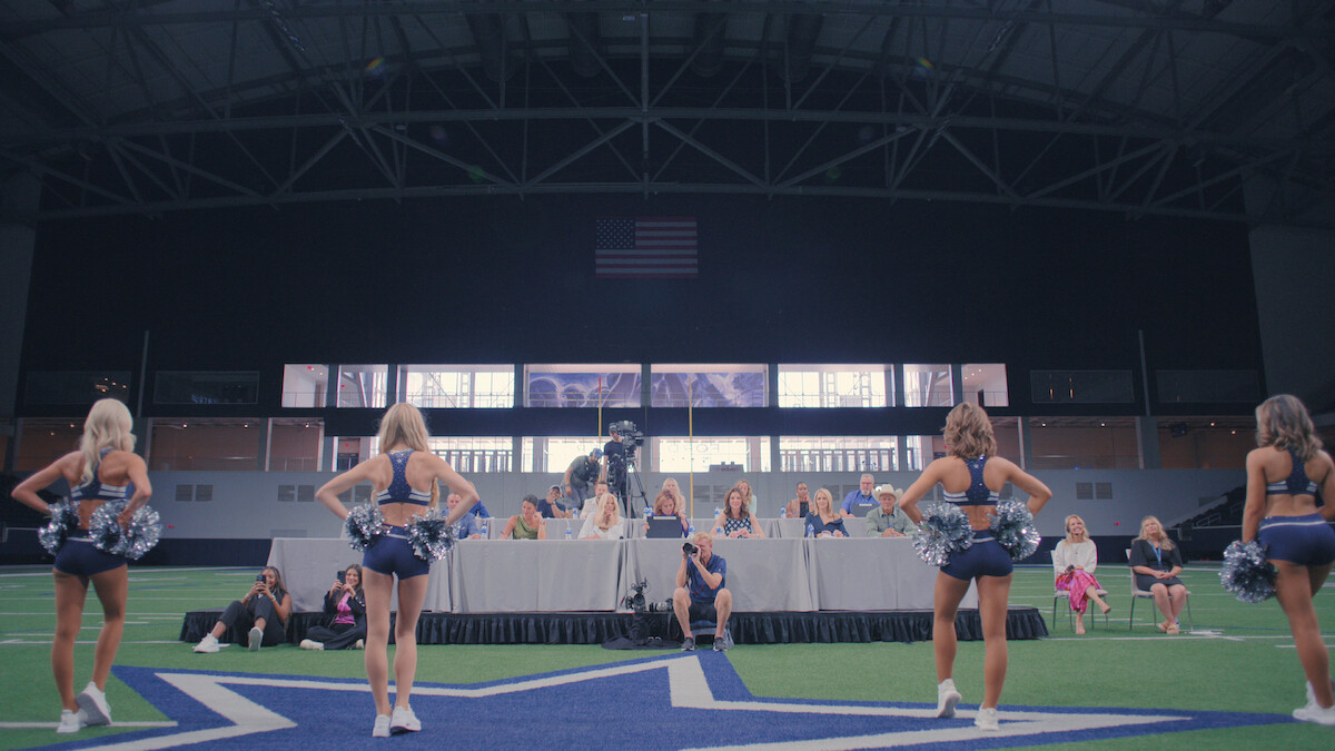 Cheerleaders train in front of Kelli Finglass and Judy Trammell.