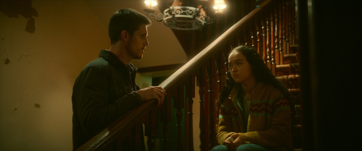 Robbie Amell as Connor, Sirena Gulamgaus as Pavani have a conversation on the stairs in ‘Code 8 Part II.’