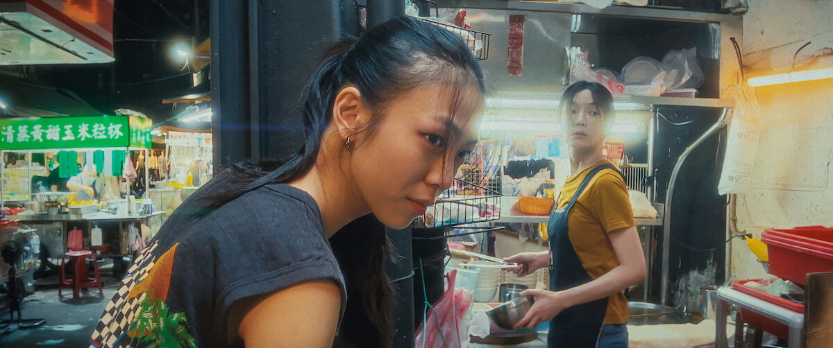 Two women work in a night market stall.