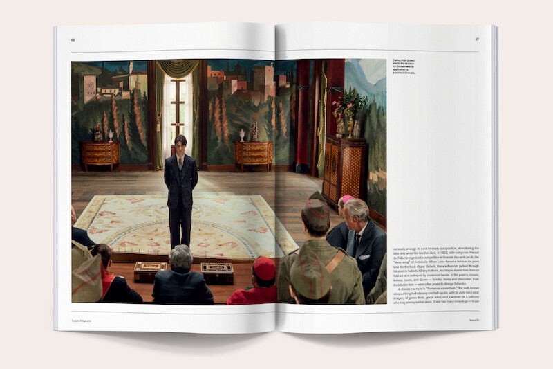 A formally dressed man stands on a rug in an ornate room with painted landscape walls and a large window, addressing an audience of seated people, some in uniform or official attire.