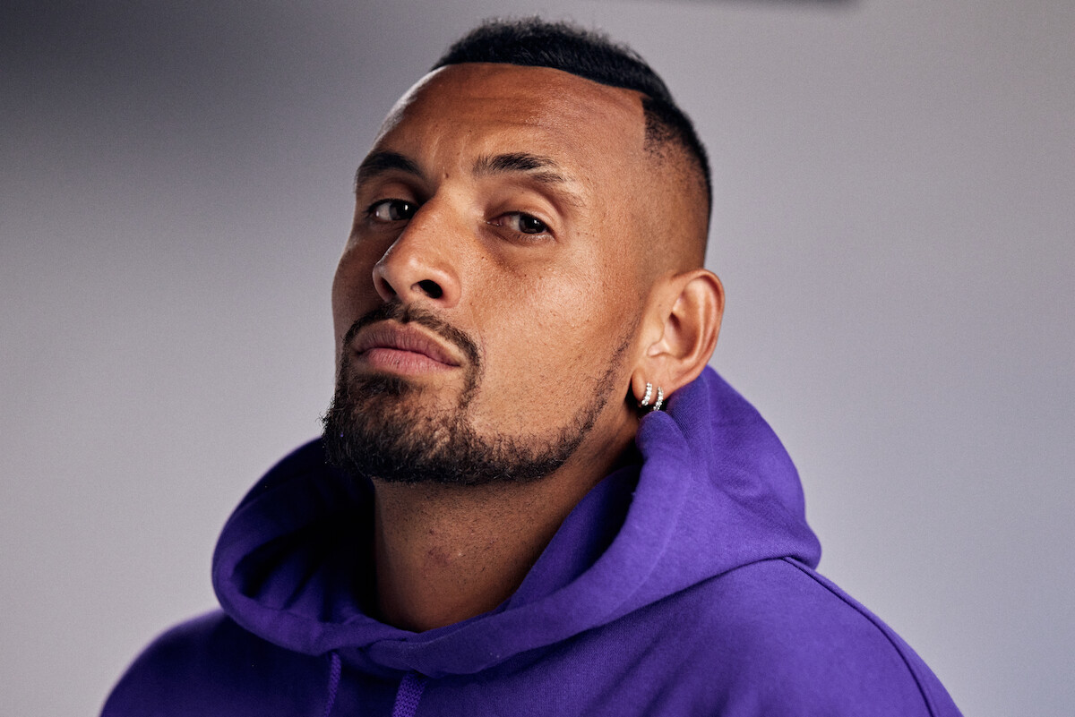 Nick Kyrgios in a purple hoodie.